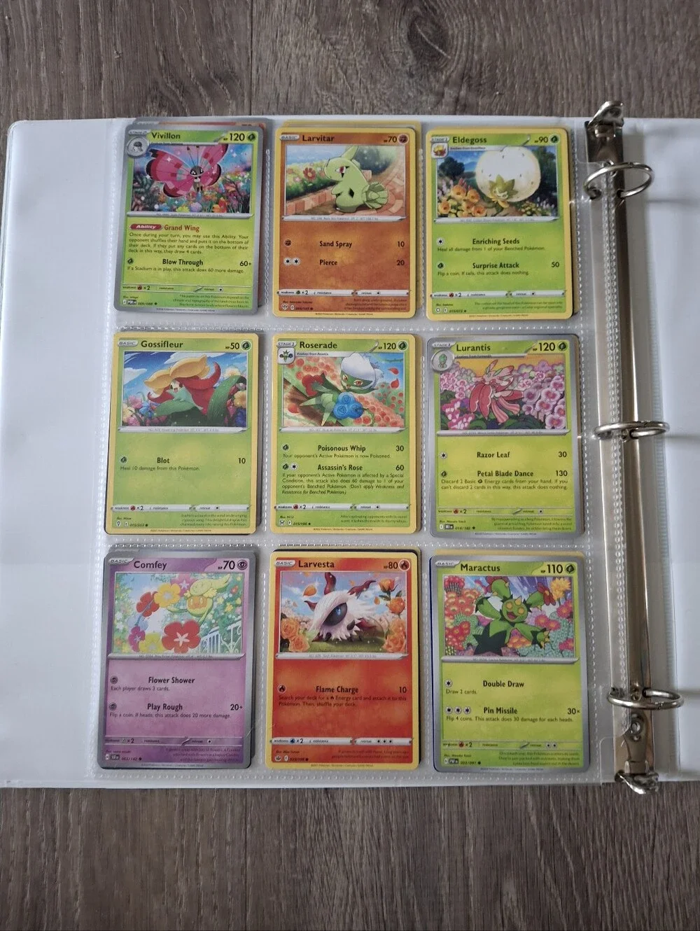 flower themed Pokemon trading cards and green binder